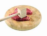 Steaks on a chopping board with Mallet