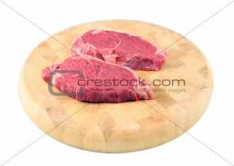 Steaks on a chopping board