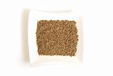 cumin seeds in square white bowl isolated