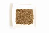 dill seeds in square white bowl isolated