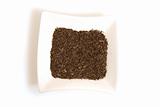 black cumin seeds in square white bowl isolated