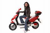 woman riding electric scooter with no helmet