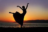 Dancing woman at sunset