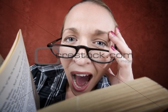 Screaming woman with big eyes reading a book