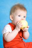 Baby boy eating an apple
