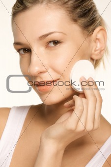 Beauty Picture of girl using a Make-Up Sponge