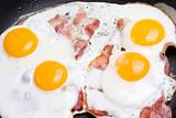 detail of ham and eggs in a pan