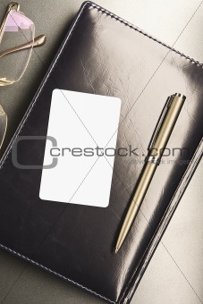 White business card lays on organizer 