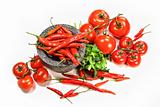 Assortment of red peppers and tomatoes on white