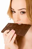 Woman eating chocolate bar - (close up)