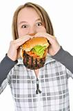 Teenage girl eating big hamburger