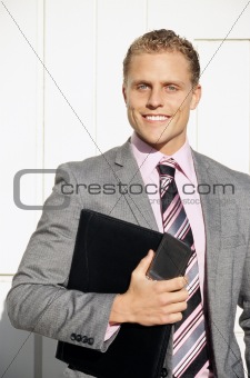 Businessman holding folder and phone
