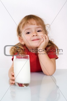 Happy little girl with milk