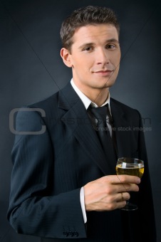 Portrait of a beautiful man with a glass of champagne