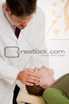 Chiropractor Adjusts Patient's Neck