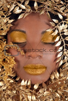 African American Woman Wrapped in Metallic Leaves