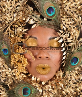 Woman Wrapped in Metallic Leaves and Peacock Feathers