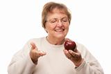 Happy Attractive Senior Woman Holding Apple and Vitamins Isolated on a White Background.