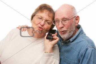 Happy Senior Couple Using Cell Phone Isolated on a White Background.