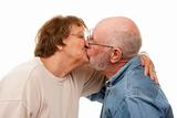Affectionate Senior Couple Kissing Isolated on a White Background.