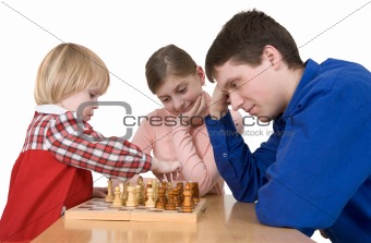 Man and child play chess