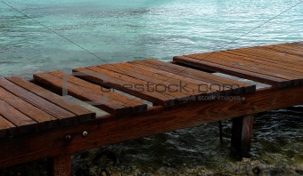 Weathered wooden pier to the ocean