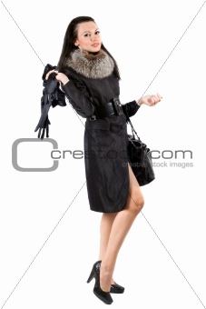The young woman in a black coat. Isolated on white