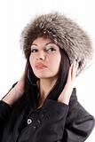 Portrait of the young woman in a fur cap. Isolated