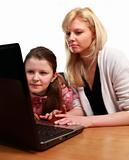 Mother Helping Child with School work on a Laptop