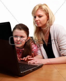 Mother Helping Child with School work on a Laptop