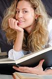 young smiling woman surrounded with books