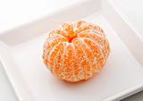 Fresh tangerine on a plate.