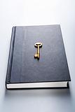 Golden key on book