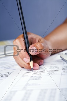 Hand working on financial report