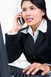 Young Asian businesswoman is on phone