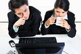 Young Asian businesspeople in office examining monitor