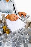 Woman working on accounting with many coins around