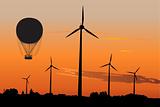 Wind generators and Air Baloon in sunrise