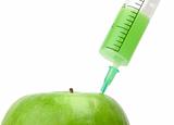 Green apple with syringe inserted