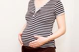pregnant woman in black and white stripped t-shirt
