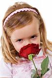 Little girl smelling a rose