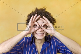 man smiling with hand over eyes