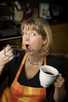 Woman eating in kitchen