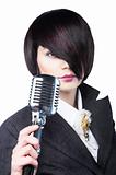 Young woman with fashion haircut holding a vintage microphone