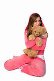 Young beautiful woman in the pink sportswear with teddy bear