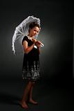 pretty young girl in black dress with white parasol