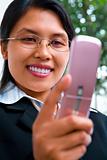Young Asian businesswoman using text messaging
