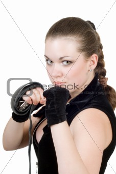 Pretty young angry woman throwing a punch over white