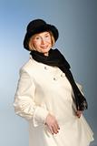 attractive older woman in winter coat & hat
