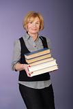 attractive older lady carrying stack of books